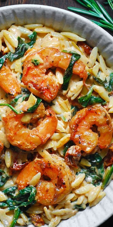 Creamy Tuscan Shrimp Pasta (Orzo) with Sun-Dried Tomatoes, Artichokes, and Spinach (30-Minute One-Pan Meal). Italian-inspired Autumn comfort food made with orzo pasta. This pasta dish is an easy weeknight meal to make during colder months of the year (Fall and Winter). #shrimppasta #pasta #comfortfood #creamyshrimppasta #creamypasta #orzo #orzorecipes #orzoideas #dinners #maindishes #maincourses #Italianfood #Italianrecipe One Pan Lemon Orzo Pasta With Shrimp, Seafood Veggie Pasta, Dishing Out Health Shrimp Orzo, Italian Shrimp And Rice Recipes, Shrimp Recipes Greek, Cooking With Orzo, One Sheet Pan Meals Shrimp, Shrimp Orzo Arugula, Shrimp With Risotto