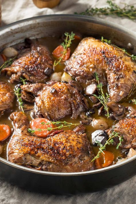 Jamie Oliver Slow Cooker Coq Au Vin is made with Pinot Noir, thick-cut bacon, chicken thighs, crimini mushrooms, shallots, garlic, carrots, chicken broth, tomato paste, fresh thyme, bay leaves, white pearl onions, unsalted butter, and flour. This hearty Slow Cooker Coq Au Vin recipe creates a hearty dinner that takes about 8 hours to prepare and can serve up to 5 people. Coq Au Vin Slow Cooker, Chicken Coq Au Vin Recipe, Slow Cooker Coq Au Vin, Butter Chicken Slow Cooker, Carrots Chicken, Coq Au Vin Recipe, Garlic Carrots, Bacon Chicken, Crimini Mushrooms