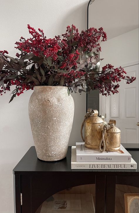 Affordable holiday stems on sale for 50% off right now. Using 3 stems here. Winter greenery, holiday stems, entryway styling, Christmas decor, Christmas stems, arch cabinet, foyer decor, target style, arch mirror, entryway mirror, Christmas bells Follow my shop @thebionicmodel on the @shop.LTK app to shop this post and get my exclusive app-only content! #liketkit #LTKSeasonal #LTKHolidaySale #LTKhome @shop.ltk https://liketk.it/4maT5 Christmas Decor Vase Ideas, Christmas Vase Decor Ideas, Christmas Floral Arrangements Diy Vase, Winter Stems In Vase, Christmas Branches In Vase, Holiday Mirror Decor, Holiday Vase Filler Ideas, Winter Vase Filler Ideas, Foyer Christmas Decor Entryway