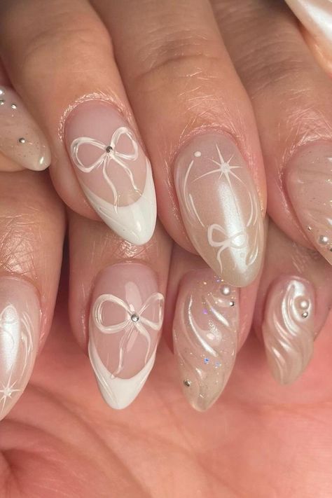 Discover the epitome of sophistication with our Sheer Nude Stiletto Nails! Adorned with delicate White Ribbon Art and dazzling Rhinestone Accents, these almond-shaped nails exude elegance. Click through to explore the entire collection and find your perfect style. 💅✨ // Photo Credit: Instagram @nailsbyfiona_ Press On Nail Kit, Pearl Nails, Prom Nails, Cute Nail Designs, Chrome Nails, Nail Kit, Perfect Nails, White Design, Nail File