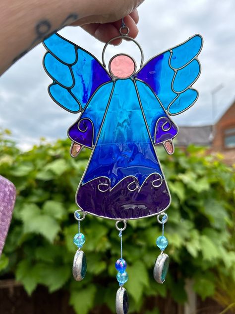 Bring a touch of whimsical charm and ethereal beauty to your space with this stunning blue Wing Angel Resin Sun-catcher. Carefully crafted with sea blue -hued wings and a delicate angelic figure, this suncatcher is sure to add a magical element to any room. Hang it in a sunlit window to watch the colors dance and sparkle, creating a mesmerizing display that will brighten your day. Perfect for uplifting your mood and adding a pop of colour to your decor, this sun-catcher makes a lovely gift for yourself or a friend. Measures Approx: 27cm (H) x 11cm (W) x 0.7cm (D) Weight (Approx): 56g Resin Suncatcher, Wing Angel, Angel Suncatcher, Bead Projects, Blue Wings, Ethereal Beauty, Sea Blue, Sun Catcher, Brighten Your Day