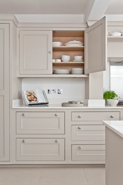 a delicate greige kitchen with shaker cabinets, white stone countertops and a matching sleek backsplash, simple knobs is a lovely idea Greige Kitchen Cabinets, Küchen In U Form, Beige Kitchen Cabinets, Greige Kitchen, Taupe Kitchen, Beige Cabinets, Kitchen Ikea, Beige Kitchen, Coastal Kitchen