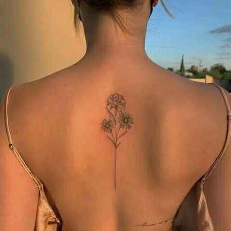 Back tattoo ideas for women Flower Bouquet Tattoo On Spine, Sunflower Back Arm Tattoo, Floral Back Tattoos Small, Carnation Tattoo Spine, Flower Spine Tattoos Simple, Fine Like Spine Tattoo, Simple Line Spine Tattoo, Flower Back Tattoo Small, Minimalist Back Tattoo Women Spine