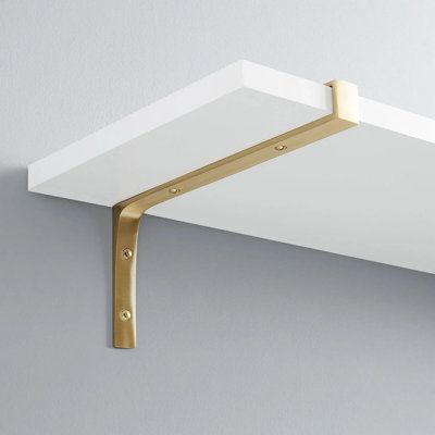 The rustic brass shelf bracket features a simple design that seamlessly works with a variety of different style projects. Signature Hardware Size: 4" H x 6" W x 0.88" D, Finish: Satin Brass | Signature Hardware Gehler Solid Brass Shelf Bracket in Satin Brass | 4" H x 6" W x 0.88" D | Wayfair Bracket Shelving, Gold Shelf Brackets, Brass Shelf Brackets, Brass Shelf, D Signature, Brass Shelves, Shelf Hardware, Shelving Accessories, White Shelves