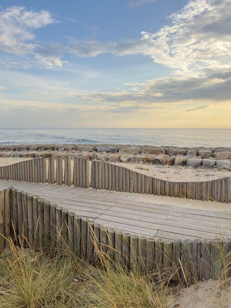 A wood pedestrian walkways, build over a sand dune that is used to give beach access in Furadouro beach, glows at sunset. Ovar, stock photography Beach Walkway, Beach Pavilion, Pavilion Architecture, Pedestrian Walkway, Beach Boardwalk, Wood Deck, Sand Dunes, A Wood, Coastal Style