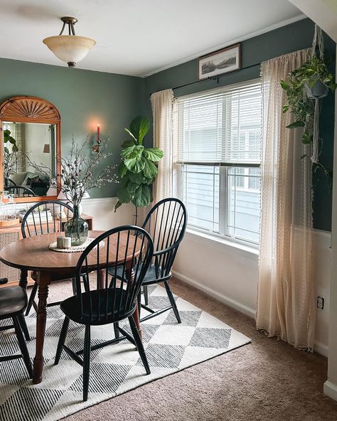 Partial dining room reveal! 🕯️🙌🏼 There is plenty left to do, but if I said I was LOVING it right now, that would be an understatement. 🥰 It’s the smallest room in the house at 10x10’, so I decided to reuse the perfectly moody @behrpaint in Peaceful Glade from the last house, and had to have this @loloi @chrislovesjulia “Francis” rug in Beige/Charcoal.🤍 I also just inherited this beautiful knotty pine mirror from my aunt, and we found the round table on FB Marketplace when we moved in. 🥂 ... Half Living Room And Dining Room, Sitting Nook In Dining Room, Small Open Living Room And Dining Room, Small Enclosed Dining Room Ideas, Boho Dining Room Small Space, Playroom In Dining Room, Cozy Family Dining Room, No Dining Room Ideas, Carpeted Dining Room Solutions