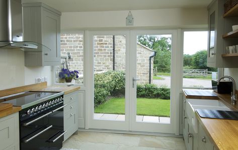 French doors with flag windows finished in Off-White, with a Satin Chrome Windsor handle and manufactured in Engineered European Redwood. Doors To Outside Patio, Kitchen Doors To Outside, Kitchen Patio Doors, Traditional French Doors, Bifold Patio Doors, Interior Design Living Room Modern, Timber Windows, French Doors Patio, Outside Patio