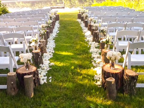 Stump Decorating Ideas Wedding, Fall Wedding Aisle Decorations Outdoor Tree Stumps, Wedding Arch With Tree Stumps, Wood Stump Wedding Aisle, Tree Stumps Wedding Aisle, Rustic Outdoor Ceremony Decor, Beginning Of Isle Wedding Decor, Mason Jar Isle Decorations, Log Stumps Wedding