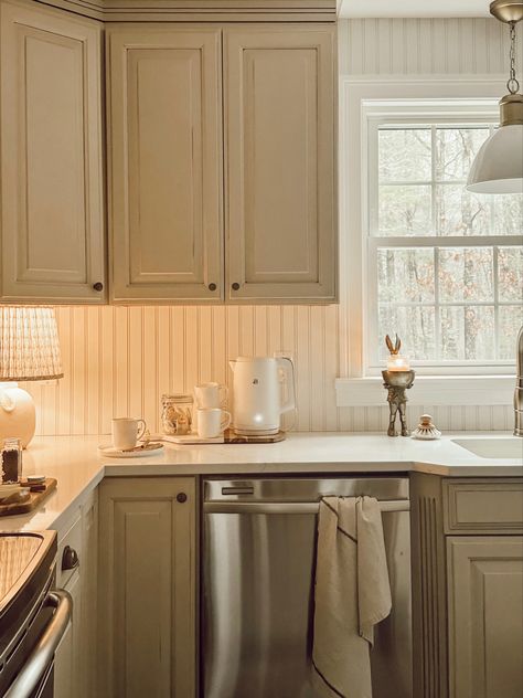 Beadboard Above Kitchen Cabinets, Beaded Cabinets Kitchen, Tan Bottom Cabinets White Upper, Country Cottage Backsplash, How To Make A Small Kitchen Feel Bigger, Breadboard Entry, Older House Aesthetic, 1930s Bungalow Kitchen, Brick And Beadboard Kitchen