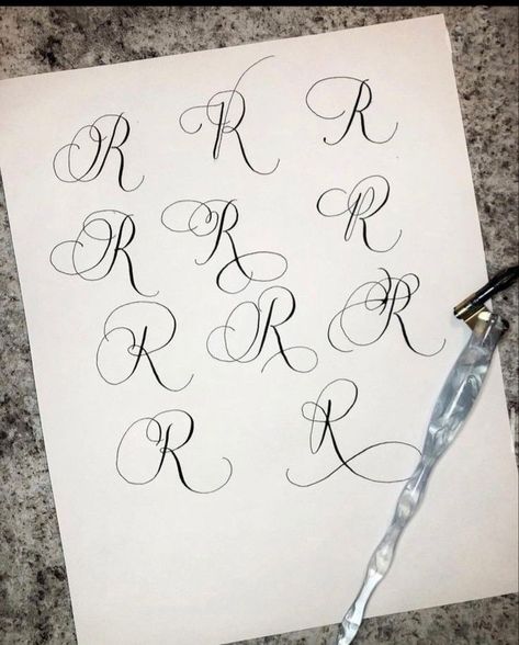 Flourishing calligraphy letter R with gold ink on textured Fonts Alphabet Cursive, Calligraphy R, Flourishing Calligraphy, Letter R Tattoo, Vintage Cursive, Cursive Fonts Alphabet, Alphabet Cursive, Fonts Elegant, Calligraphy Letters Alphabet