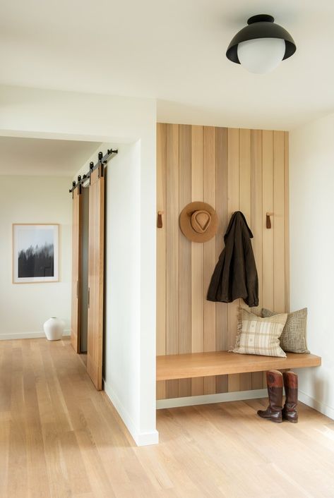 The natural wood paneling detail is carried throughout the house from the exterior siding, through the entry, and then into the great room for cohesion. Photo 1 of 14 in Modern Montana Retreat by Christine Callaghan. Browse inspirational photos of modern homes. Natural Wood Paneling, Entry Nook, Entrance Bench, Mudroom Remodel, Entryway Modern, Diy Mudroom, Mudroom Entryway, Modern Entry, Mudroom Decor