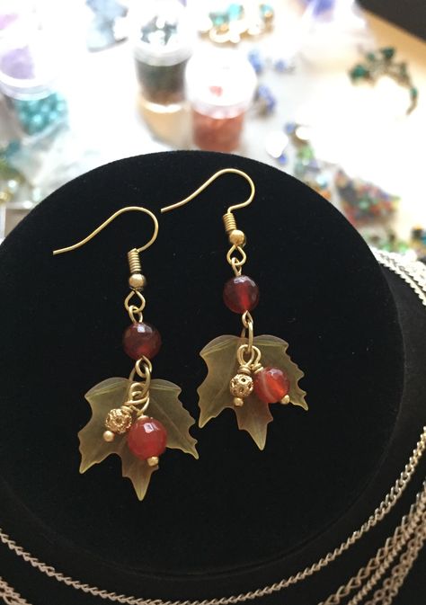 Lucite maple leaf earrings with gold filigree ball and carnelian crystal drops #diyearrings #falljewelry #mapleleaf Autumn Handmade Jewelry, Thanksgiving Jewelry Diy, Autumn Earrings Diy, Fall Inspired Jewelry, Fall Bead Jewelry, Fall Leaf Earrings, Fall Earrings Beaded, Maple Leaf Earrings, Fall Earring Ideas