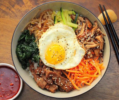 This Authentic Bibimbap is Korean comfort food at it's best. Omit the seasoned Korean beef and you've got a great vegetarian dish. Really good! Korean Comfort Food, Koreansk Mad, Bibimbap Recipe, Beef Food Recipes, Seasoned Veggies, Korean Food Recipes, Korean Dishes, Korean Recipes, Bulgogi