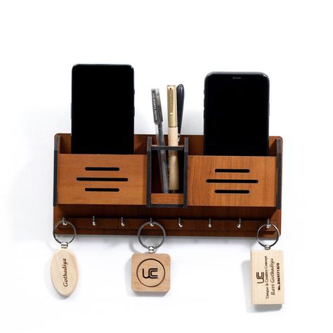 This beautiful, handmade key hanger is made of solid wood and features a unique mobile stand that allows you to easily access your keys. It's the perfect way to keep your keys organized and within reach, and it makes a great gift for anyone who loves unique home.#laserkeyholder #keyorganization #customkeyholder #keyaccessories #keyholderdesign Mobile Stand Wooden, Key Stand, Wall Decora, Wooden Mobile, Hotel School, Wooden Key Holder, Laminated Mdf, Pen Stand, Mobile Stand