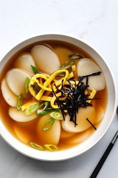 Korean New Year's Food Tradition: Rice Cake Soup (Duk Guk) Tteokbokki Soup Recipe, Korean New Year Soup, Rice Cake Soup Korean, Korean New Year Food, Duk Guk Recipe, Korean Dishes Traditional, Tteokbokki Soup, Rice Cake Recipes Korean, Korean Soups And Stews