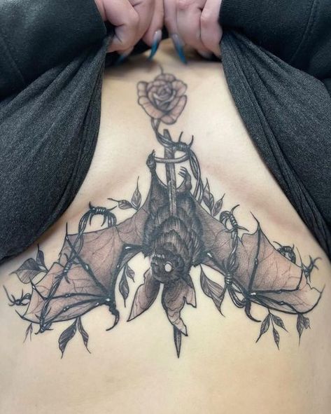 Be unique. Be different. Find a breast tattoo idea that reflects your personality. More than 50 unique and latest ideas are collected in our article. Bat Wrapped Around Wrist Tattoo, Gothic Tattoo Ideas Female, Horizontal Forearm Tattoo, Gothic Rib Tattoo, Thigh Tattoos Goth, Spooky Butterfly Tattoo, Bat Tattoo Sternum, Goth Spine Tattoo, Sternum Bat Tattoo