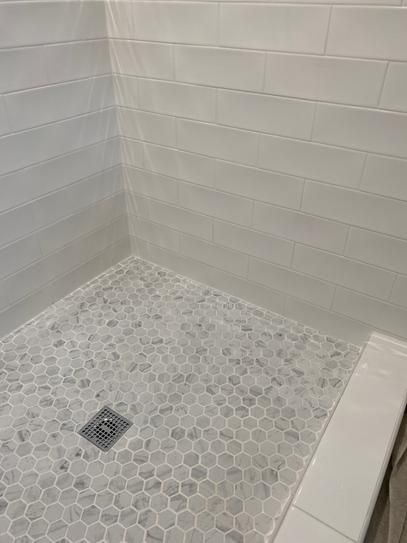 Lifeproof Carrara 10 in. x 12 in. x 6.35mm Ceramic Hexagon Mosaic Floor and Wall Tile (0.81 sq. ft. / piece)-LP5015HEXHD1P2 - The Home Depot Marble Mosaic Shower Floor, Bathroom Mosaic Tile Ideas, White Subway Tile Shower Gray Hexagon Floor, White Hexagon Shower Floor, Hexagon Tile Bathroom Shower Wall Lowe's, Satori Regent Carrara Nevoso Hexagon, Gray Hexagon Shower Floor, Carrara Marble Hexagon Tile, Shower Pan Tile