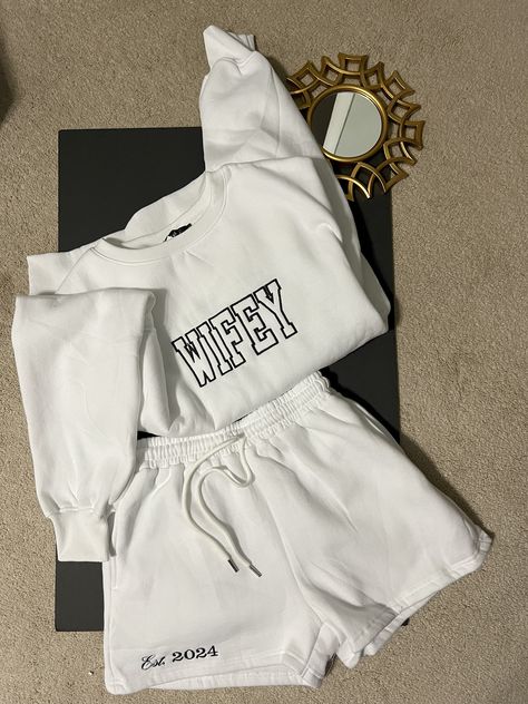 Are you a newlywed or celebrating your love journey? Our personalized "Wifey" Sweatshirt and short set is the ultimate blend of comfort and chic.   The shorts are customized with an "est 202X" year to showcase the special occasion. Embroidered.  Will not fade    NOW AVAILABLE IN SHORT SLEEVES -message me for details  #Bride #wifey #honeymoon #bacheloretteparty #Forthebride Comfy Getting Ready Outfit Wedding, Bridal Party Airport Outfit, Casual Bride Reception Outfit, Bride Plane Outfit, Bridal Honeymoon Outfit, Bridal Fits, Get Ready Wedding Outfit, After Reception Outfit Brides Comfy, Bride Sweat Suit Wedding Day