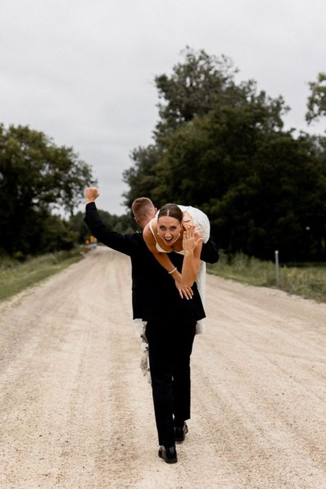 Groom walks away carrying bride over his shoulder as he celebrates with a fist in the air while bride flashes a smile and shows off her stunning wedding ring. Unique Wedding Poses, Groom Wedding Pictures, Fun Wedding Pictures, Wedding Photo List, Bride Groom Poses, Groom Photoshoot, Wedding Portrait Poses, Bride Pictures, Wedding Couple Photos