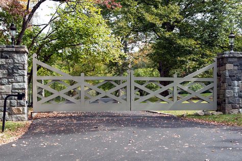 A ranch-style driveway gate with an updated look. The gray paint on this wooden gate gives a modern touch to a traditional style. Farm Front Gate Entrance, Farm Driveway Gate, Stable Yard Gates, Ranch Enterence Gates, Long Gated Driveway, Farm Gates Entrance, Wood Gates Driveway, Farm Entrance, Wooden Gates Driveway