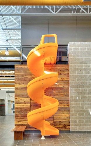 Gloria Marshall Elementary School / SHW Group. Interactive nodes throughout hallway. Pallet Sculpture, Children Architecture, Yellow Slides, Bibliotheque Design, Events Place, Indoor Slides, Stairs Architecture, School Interior, Nursery School