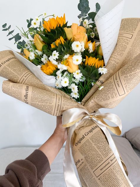 Sunflower wrapped bouquet Sunflower Bouquet Wrapped In Paper, Flower Bouquet Newspaper, Bouquet In Newspaper, Bouquet Wrapped In Newspaper, Flower Bouquet Newspaper Wrap, Flowers In Newspaper Bouquets, Newspaper Wrapped Bouquet, Newspaper Bouquet Wrap, Newspaper Wrapped Flowers