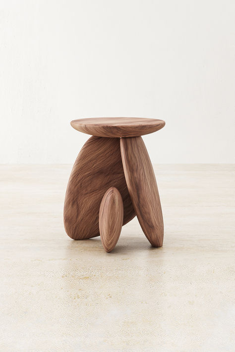 Crafted from the esteemed Raintree wood, the Pebble Side Table is a masterpiece of natural allure and sophistication. Its surface, inspired by the smooth contours of river stones, provides a tactile experience as refined as its appearance. Below, three elegantly carved legs, reminiscent of the pebbles that grace serene brooks, form a tripod base that ensures both stability and a visually pleasing aesthetic. Side Table Base Ideas, Pebble Side Table, Luxury Wood Furniture, Wood And Stone Table, Organic Shape Furniture, Natural Furniture Design, Aesthetic Wood Furniture, Japandi Side Table, Funky Side Table