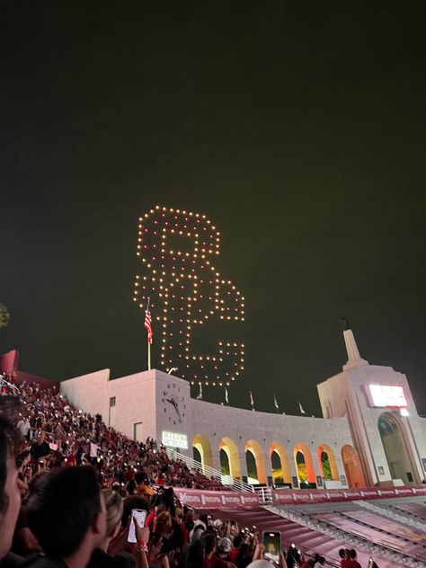 SC. Southern California. LA Coliseum. USC football game. Night. Drones. College football stadium Usc Gould Law, Usc Football Aesthetic, Usc University Aesthetic, Usc College Aesthetic, Usc Aesthetic Wallpaper, University Of Southern California Aesthetic, Usc Grad Cap, Usc Aesthetic, Usc Tailgate