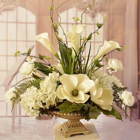 Cream Magnolia and Hydrangeas with Calla Lillies AR413 .Elegantly styled silk flower centerpeice arranged with soft cream hydrangeas, magnolias, and calla lillies. Accented with wispy branches, ranunculus and fern. This beautiful silk arrangement is displayed in a champagne pedestal vase. Measures 24"H x 23"W x 16"D Silk Floral Centerpiece, Orchid Centerpiece, Gold Pedestal, Silk Flower Centerpieces, Orchid Centerpieces, Large Floral Arrangements, Hydrangea Centerpiece, Large Flower Arrangements, January Wedding