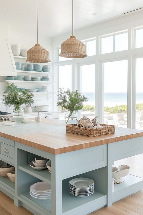 Transform your home with the latest kitchen design trends! This light and airy coastal kitchen showcases sleek open shelves, pastel blue cabinetry, and natural wood elements for a serene vibe. Perfect for a beach-inspired look. #KitchenDesign #HomeDecor #CoastalLiving Big Coastal Kitchen, New England Beach House Kitchen, Coastal Interiors Design Kitchen, Coastal Color Kitchen Cabinets, Coastal Modern Farmhouse Kitchen, Colorful Coastal Kitchen, Modern Coastal Kitchen Table, Coastal Beach House Kitchen, Light Blue And Wood Kitchen