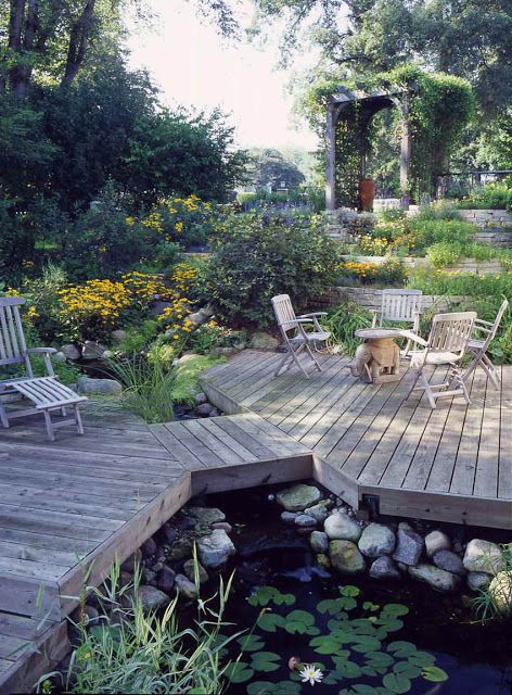 This unique deck dissects the pond, providing multiple viewing areas to enjoy the abundant aquatic plants and surrounding landscape. #backyardideas #pond #aquaticplants #deck #landscapedesign Building A Pond, Garden Pond Design, Outdoor Ponds, Fountains Backyard, Pond Water Features, Backyard Water Feature, Pond Landscaping, Natural Pond, Piscina Natural