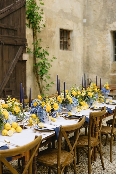 The contrasting colors of blue and yellow florals by Eventfloristin Beate Lohner-Spohn gently stood out amidst the courtyard of the castle. Vows were exchanged in front of a small courtyard pond with a delicate fountain. Yellow Blue Wedding Theme, Yellow Blue White Wedding, Lemon Inspired Wedding, Meditterean Wedding, Light Blue And Yellow Wedding Theme, Italian Lemon Wedding Theme, Tuscany Wedding Table Decor, Lemon Blue Wedding, Classical Wedding Theme