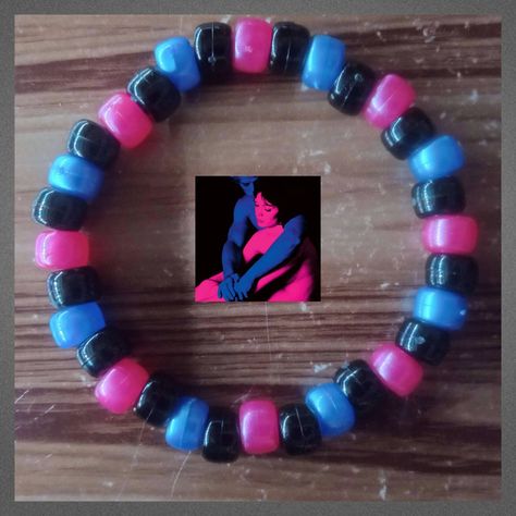 Kandi single inspired by Tv Girl's "Who Really Cares" album.  The Pink and blue beads are shiny! 💙 Please message me if you need a bigger/smaller size before ordering, as these bracelets are not adjustable. Pink And Blue Jewelry, Domo Kandi Pattern, Barbie Kandi, Kandi Bracelets Scene, Kandi Inspo Single, Bead Bracelets Words Ideas, Who Really Cares Album Cover, Single Kandi Ideas, Space Kandi