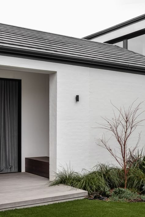 This large family residence is composed of two masonry and tiled gable roof structures, a contemporary but contextual response to the more traditional homes in the leafy hillside street. #melbourne #home #modern #contemporary #builder Modern Brick House Exterior, Rendered Houses, Painted Brick Exteriors, Roof Cladding, Melbourne Home, Exterior Tiles, Brick Cladding, House Cladding, Dark House