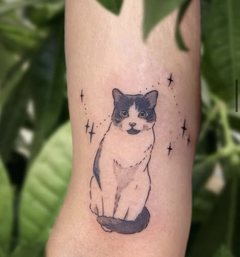 A minimalist cat tattoo can be a charming and subtle way to express your love for felines. Consider a simple outline of a cat's silhouette, perhaps with clean lines and minimal detail. You could opt for a small design on your wrist, ankle, or behind the ear for a discreet yet stylish look. Black ink tends to work well for minimalist tattoos, but you could also explore other subtle colors if you prefer. Just ensure you find a talented tattoo artist who specializes in minimalist designs White And Black Cat Tattoo, Porcelain Cat Tattoo, Cat Tattoo Tuxedo, Custom Cat Tattoo, Pet Tattoos Cat Memorial, Cat Tattoo Designs Memorial, Tortie Cat Tattoo, Cat Tattoo Portrait, Pet Cat Tattoo