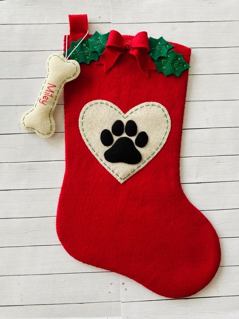 **THIS IS A PDF PATTERN DOWNLOAD. ** No finished product will be shipped.  Add a special touch to your home this holiday season with this beautiful felt stocking!  With your purchase, you will receive the PDF pattern download for this paw print felt pet stocking and the fish and bone shaped name tag ornaments.  This is a full size stocking, measuring roughly 18" diagonally. It is designed to be a fully functioning stocking that can be used by your family for years. This is a fantastic handmade g Christmas Stockings Sewing, Dog Clothes Patterns Sewing, Cat Christmas Stocking, Hanging Christmas Stockings, Christmas Gift Handmade, Dog Christmas Stocking, Pet Stockings, Stocking Designs, Dog Stocking