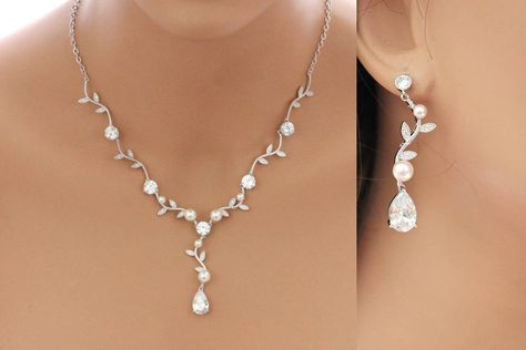 "I have combined two wonderful pieces of wedding jewelry into this lovely bridal jewelry set. I made these vine crystal necklace and earrings with platinum plated sinuous vine links onto which I securely hand wrapped beautiful Swarovski pearls.  Crystal drops sparkle and catch the light. This silver necklace set is the perfect wedding accessory and can make a beautful set for your bridesmaids. * Bridal necklace is on an 18\" chain with 2\" extender. * Matching earrings measure 2\" long. * Availa Bridesmaid Jewelry Set, Grandmother Jewelry, Silver Necklace Set, Bridal Jewelry Set, Crystal Jewelry Sets, Prom Jewelry, Bridesmaid Jewelry Sets, Popular Jewelry, Jewelry Bridal