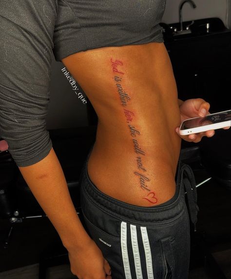 Side Of Stomach Tattoo For Black Women, Side Stomach Tattoos Women Quotes, Side Word Tattoos Women, Red Word Tattoos For Women, Baddie Stomach Tattoos, Side Tattoos Women Ribs Quotes, Side Tattoos Black Women, Female Tattoos Black Women, Stomach Side Tattoos