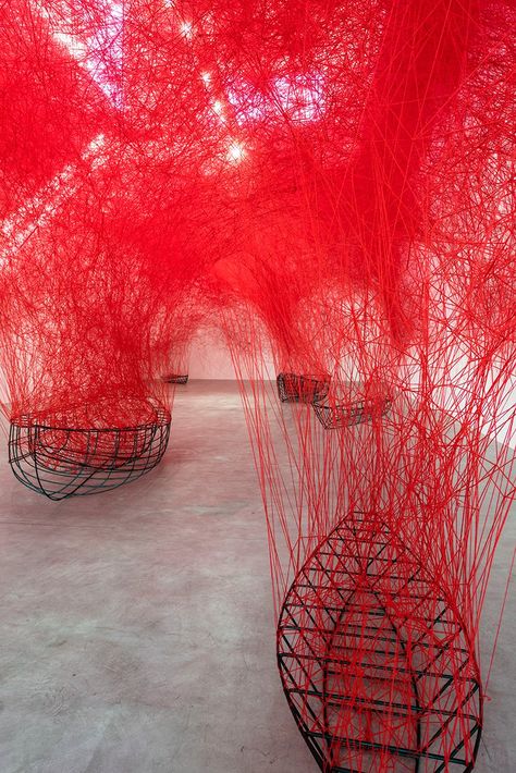 chiharu shiota tethers a labyrinth of red yarn to boat carcasses at blain|southern Installation Art Ideas, Chiharu Shiota, Dragon Decor, Luxor Egypt, Interactive Installation, Red Yarn, User Experience Design, Future City, Art Installation