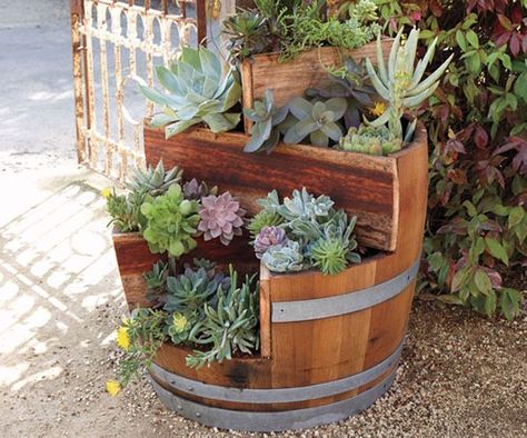 19 Interesting Ways Of Using Wine Barrels In Home Décor    http://www.homedit.com/19-interesting-ways-of-using-wine-barrels-in-home-decor/ Wine Barrel Garden, Wood Barrel Planters, Barrel Flowers, Wine Barrel Planter, Patio Plans, Barrel Projects, Tiered Planter, Barrel Planter, Unique Planter