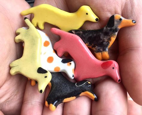 Lots of great little dachshund, doxie, teckel, weenie and sausage doggie gifts for friends and loved ones from artisan magnets and pins to dachshund chopstick rests and pots! Based in Canada with lots of free shipping options! Check out the etsy shop! All slowly made by hand with love! #Rollingdesigns #Ceramicmagnet #Ceramicpin #Ceramic #Giftideas, #Littlegifts #Animallovers #Cute #giftsforfriends #Homedecor #Homeoffice #Magnets #dachshundgift #dachshundmom #handmade #dachshund #doxie #teckel Ceramic Magnets Ideas, Clay Dachshund, Dachshund Crafts, Ceramic Dachshund, Diy Dog Gifts, Ceramic Magnets, Oakville Ontario, Clay Magnets, Air Dry Clay Projects