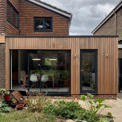 A contemporary rear extension clad in cedar, opening up a kitchen/dining/family room and making a new utility. Designed by BBD Architects Timber Clad Extension Brick House, Cladding Extension Ideas, Wood Cladding Extension, Cedar Cladding Garden Room, Extension Ideas Exterior, Cedar Wood Cladding Exterior, Cedar Extension, Clad Extension, Wood Bungalow