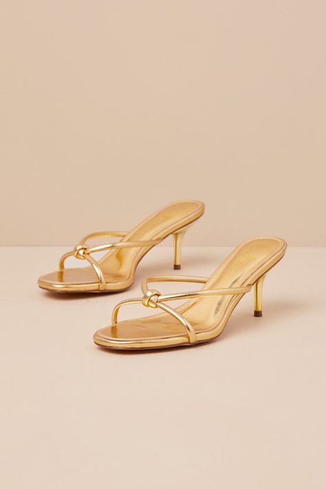 The Lulus Victoire Gold Knotted Strappy High Heel Slide Sandals are here to complete all your simply stunning date night looks! These strut-worthy sandals have a shiny faux leather construction that shapes an open-toe upper and an almond-shaped footbed. Crisscrossing straps boast a knotted detail atop the slide-on silhouette that sits atop a flirty stiletto heel. 2. 75" wrapped stiletto heel. Cushioned insole. Rubber sole has nonskid markings. Man made materials. Imported. Lulus | Victoire Gold Hoco Sandals, Vacation Heels, Hoco Heels, Vacay Fits, Gold Kitten Heels, Date Night Looks, Gold Slides, Elegant Heels, Fancy Nancy