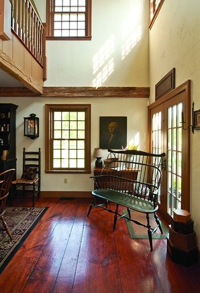 12-over-12 windows, hand-stained wide-plank flooring, and 18th-century barn beams are featured throughout the home. - DEBORAH DEGRAFFENREID Colonial Home Interior, Colonial House Interior, Early American Homes, Early American Decor, Colonial Home Decor, Primitive Living Room, Colonial Farmhouse, Colonial Interior, Colonial Furniture