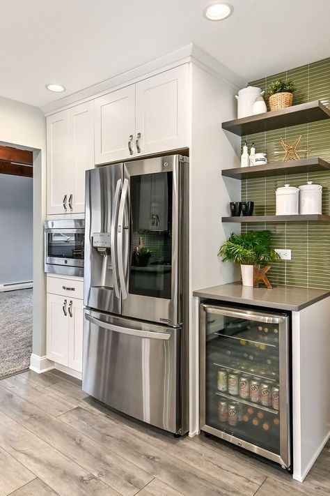 We added an appliance wall, with a full-sized refrigerator, microwave pantry, and beverage center for the kids. Open shelving above, and storage for the coffee maker and toaster, make this area a great breakfast prep spot. Green Glass Tile Backsplash, Microwave Pantry, Bar Coffee Station, Green Glass Tile, Refrigerator Cabinet, Beverage Bar, Breakfast Prep, Diy Kitchen Renovation, Beverage Center