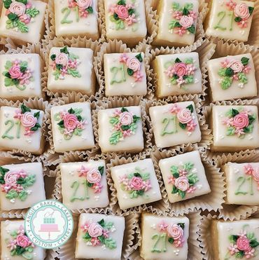 21st birthday petit fours with pink rosettes and flowers Birthday Petit Fours, Wedding Shower Petit Fours, Floral Petit Fours, Pink Petit Fours, Petit Fours Decorations, Wedding Petit Fours, Petit Fours Wedding, Coquette Bachelorette, Petite Desserts