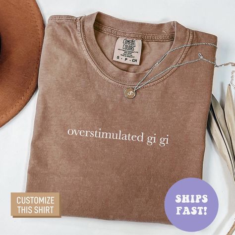 This Comfort Colors® Overstimulated Gigi Shirt is the perfect mother's day gift, birthday gift, or Christmas gift for all gigis! All of our shirts are made with the highest quality materials and are super soft and cozy! 💚 HOW TO ORDER 💚 1. Check our photos for sizing and color options. 📏 2. Choose your quantity.  Feel free to add as many shirts as you wish! ✨ 3. Select your size and color from the drop-down menus. ✨ 4. Click "ADD TO CART" to add the shirt to your virtual cart. 🛒 5. Click "PROCEED TO CHECKOUT" to purchase your shirt. 🛒 6. Your shirt is now off to production!  We will process your order and your shirt will be ready for shipment in 1-4 days! 🎁 📏 SHIRT SIZING All of our shirts come in a variety of colors and many different sizes! ✨ SHIRT INFORMATION + MATERIAL Our unise Gigi Shirts, Grandma Shirts, Mothers Day Shirts, Comfort Colors, Color Options, Mothers Day, Birthday Gifts, Gifts, Color