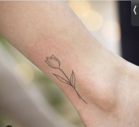 Tulip Tattoo On Ankle, Minimalist Tulip Tattoo, Fine Line Tulip Tattoo, Flower Outline Tattoo, Pisces Tattoo Designs, Mum Tattoo, Side Wrist Tattoos, Iris Tattoo, Tulip Tattoo