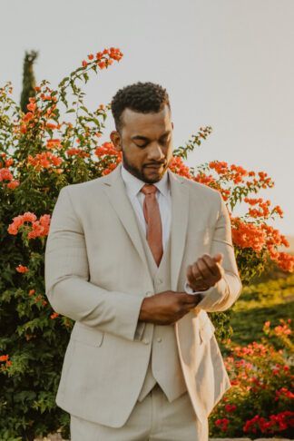 Click to see more of this outdoor winery sunset wedding ceremony filled with romantic, rustic wedding decor and flowers. https://www.confettidaydreams.com/rust-terracotta-burnt-orange-sunset-wedding/ Natural Suit Wedding, Burnt Orange Weddings Groomsmen, Men Beige Suit, Suit Summer Wedding, Burnt Orange Suit, Suit Beach Wedding, Summer Wedding Suit, Coral Wedding Cakes, Beach Wedding Suits