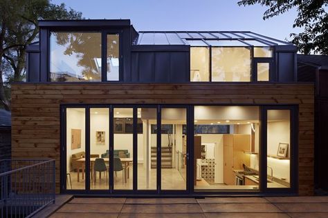 In order to maximize space, the architects utilized a split-level design that includes the living areas on the main level, two upstairs bedrooms, and a walk-out basement beneath the dining room. The wood siding was salvaged and restored from the previous building on-site, in order to bring warmth to the gray, seamed metal and reference the neighborhood's past. Polished Cement Floors, Laneway House, Garden Suite, Concrete Roof, Condo Living, Wood Siding, Home Design Ideas, Split Level, Interior Architect